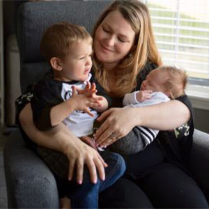 Mom's perspective. Photgraph of a mom holding her two boys.