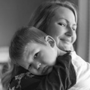 Black and white photo of a mother holding her son.