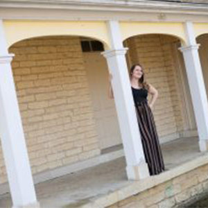 Photograph of Jessie contemplating life on a porch.