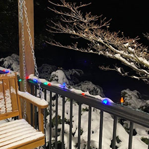 The Valley of Winter blog image. Photo of a snow-covered porch overlooking a field.