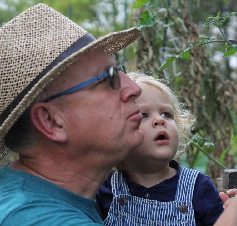 Blue Eyes blog featured image. Photo of Jessie's father holding her son looking, both looking out at nature.