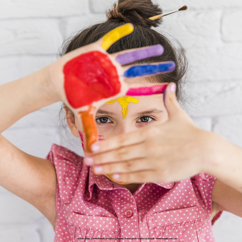 What Is ABA Therapy blog. Photo of a young girl with paint on her hands and face.