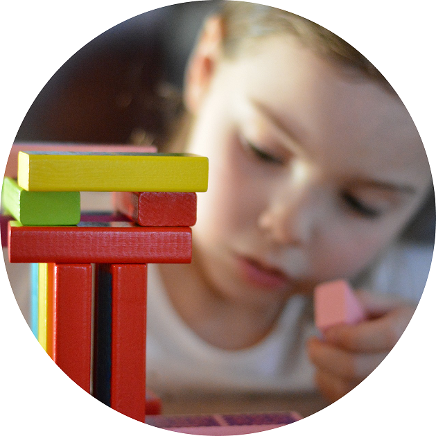 Early Indicators of ASD blog image. Photo of a young girl playing with blocks.
