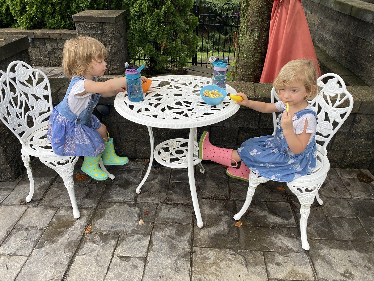 This One's For the Girls blog featured image. A photo of Jessie's nieces having a tea party outside.