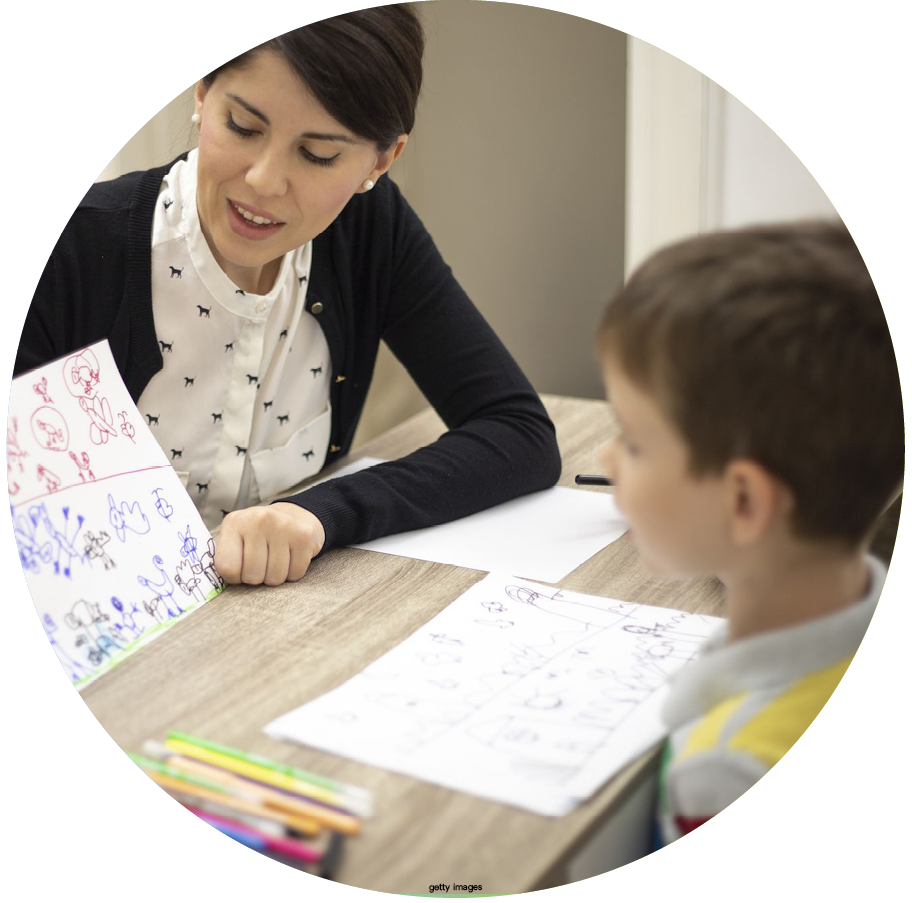 Who can help with Autism blog image. Photo of a therapist working with a child.