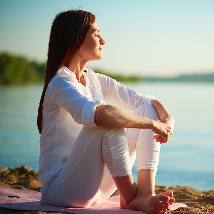 A Nurtured Heart & Body blog. Photo of a woman meditating on a beach.